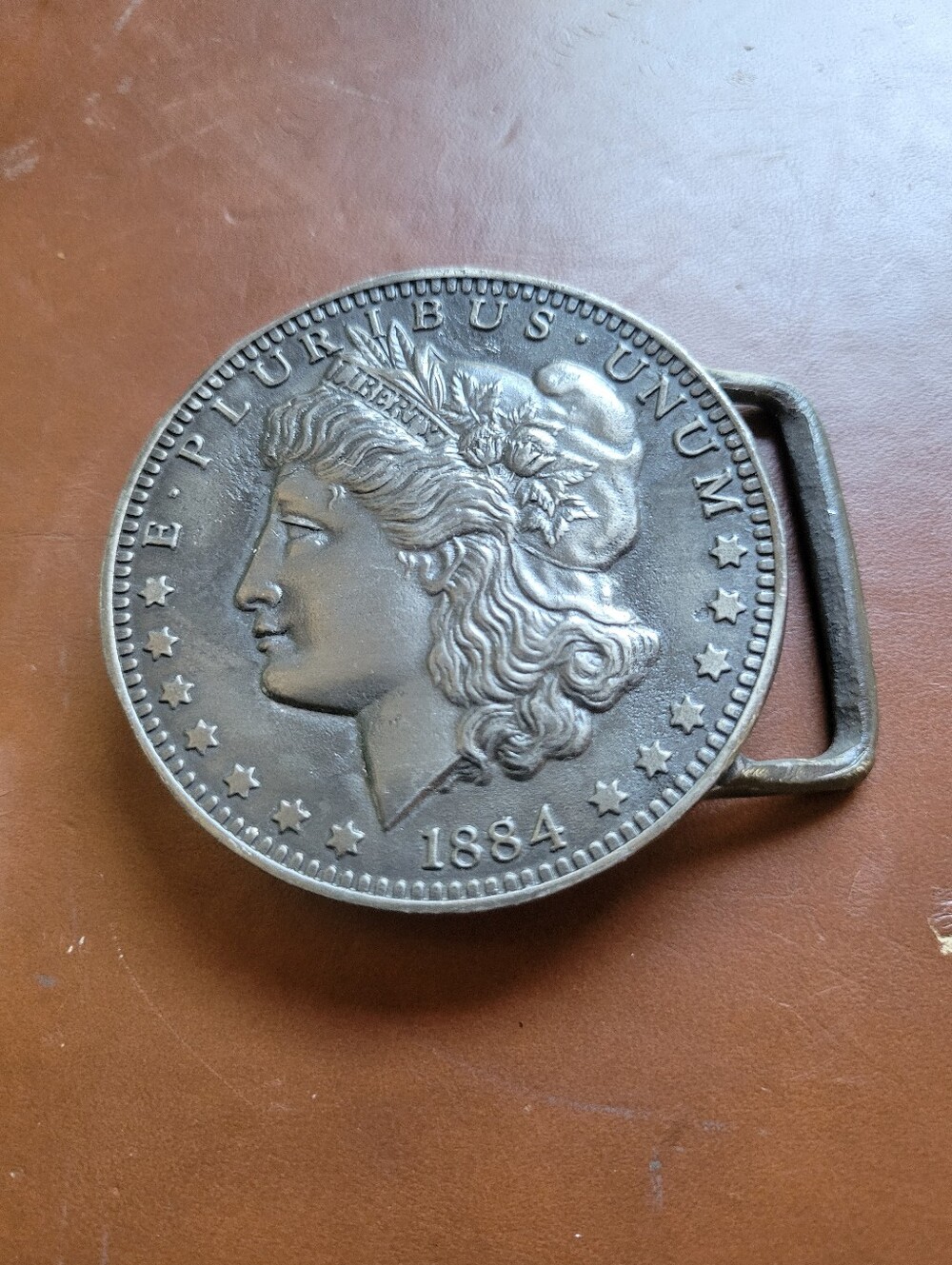 Vintage 1975 Buck-L-Up "1884 Morgan Silver Dollar" Replica Belt Buckle.
